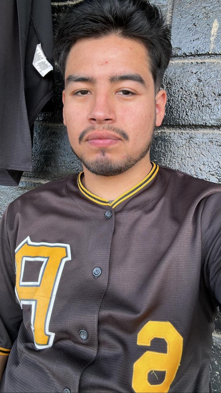 Bryan Mora staring at the camera with a baseball shirt